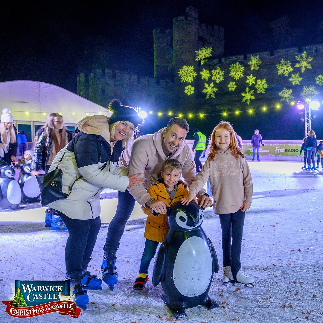 Family skating on Ice Rink at Christmas at the Castle at Warwick Castle