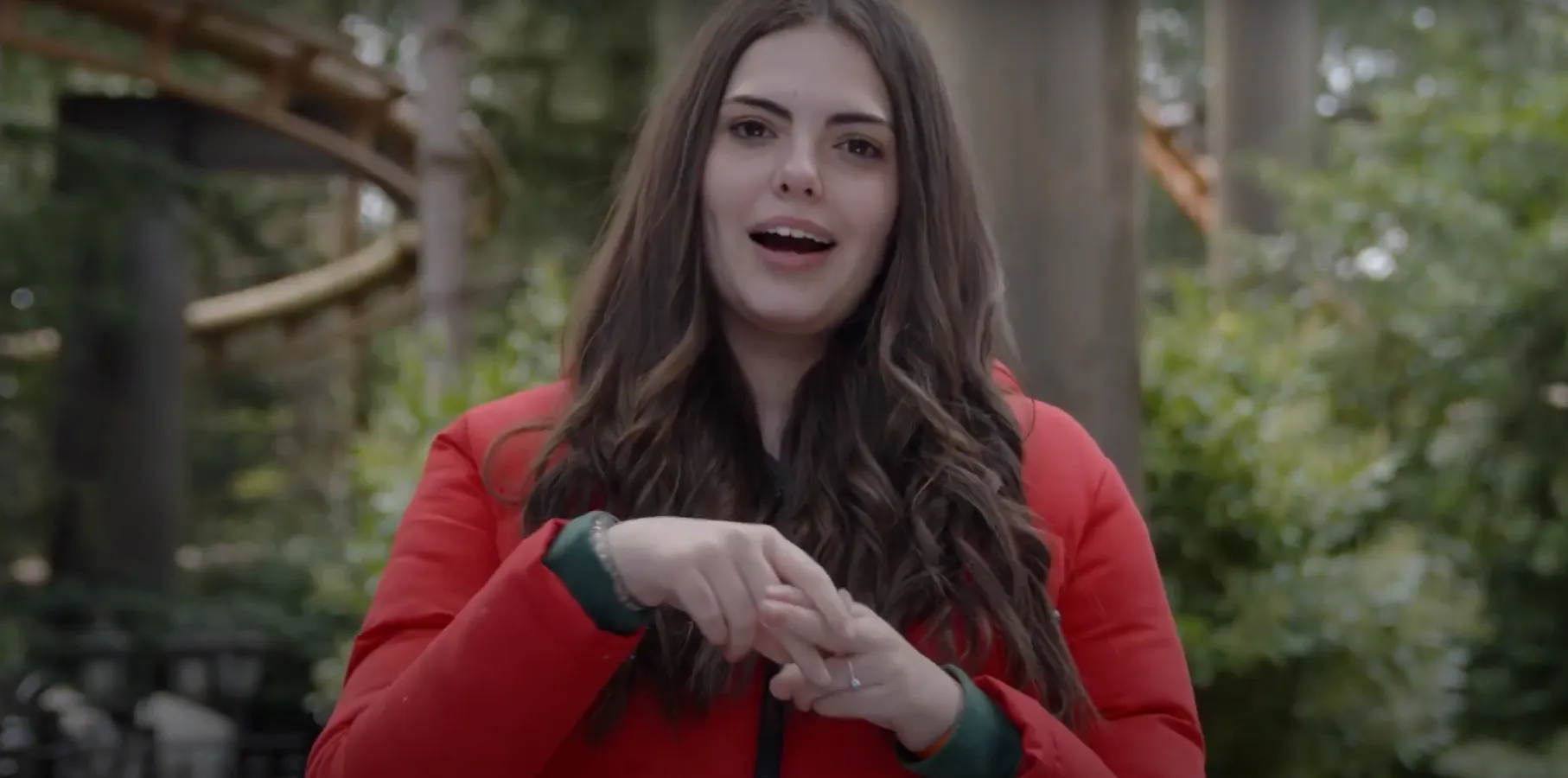 Isabella Signs explaining about Ride Access Passes at Merlin Attractions